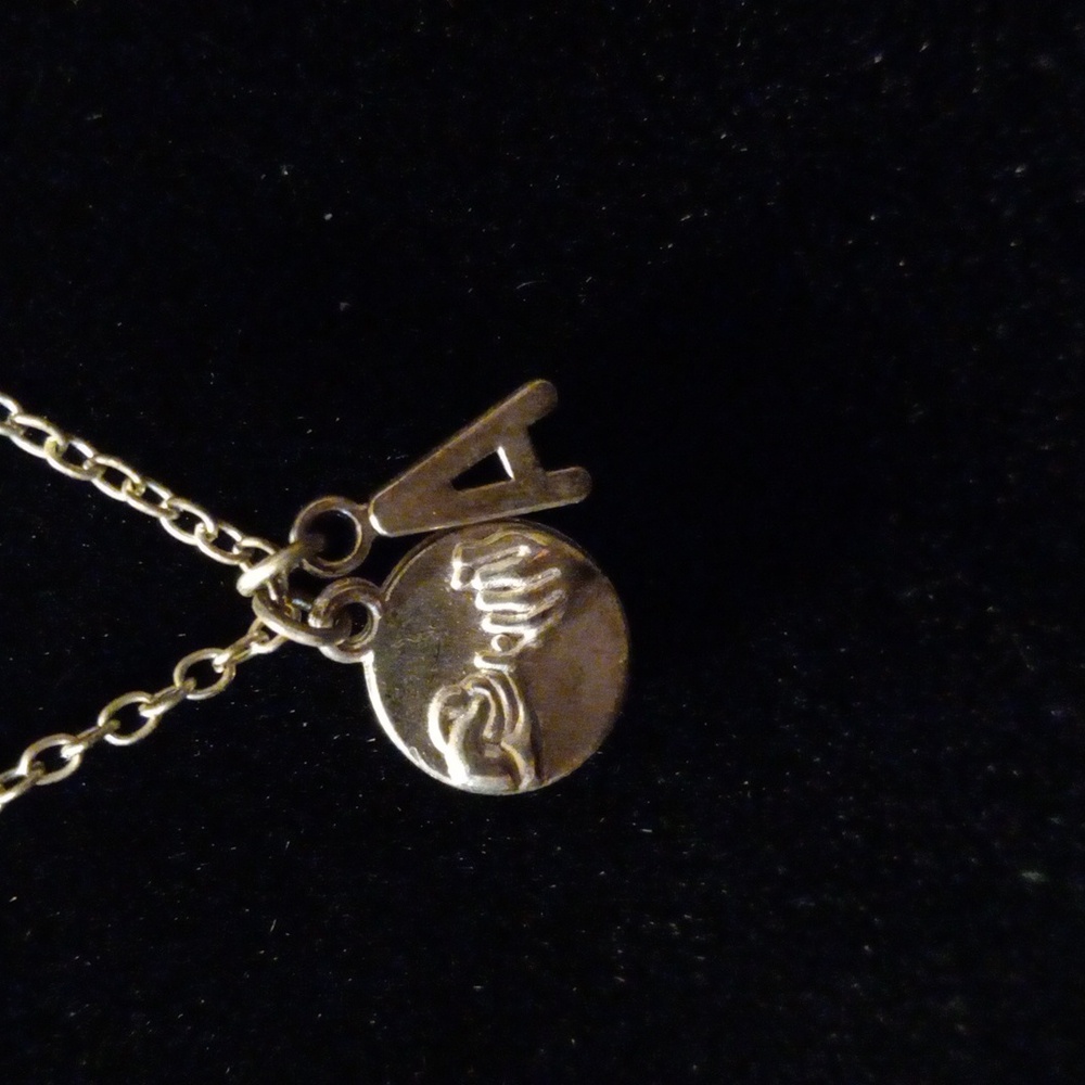 Pinky promise pendant. Also an A charm on a 16 inch gold tone chain